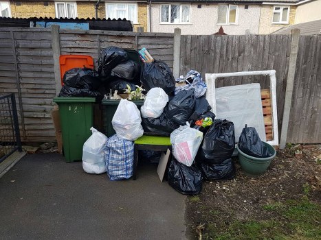 Workers using PPE and segregating waste into bins